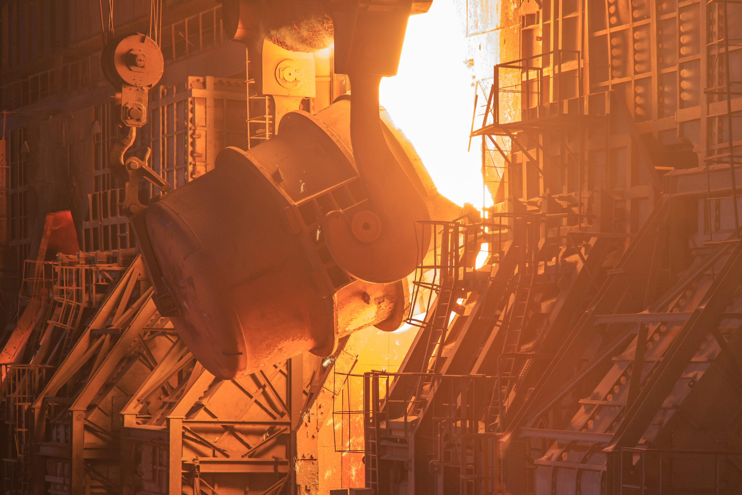 At a steel production process utilizing basic oxygen furnaces, a tank pours molten steel into forms.